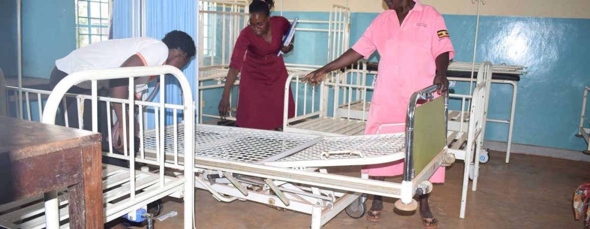 IDIWA Staff being shown an adjustable bed in the labour ward by midwife Mbulamuti HC III