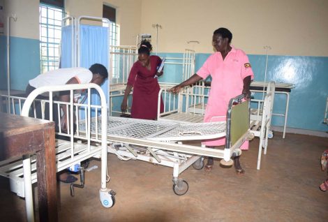 IDIWA Staff being shown an adjustable bed in the labour ward by midwife Mbulamuti HC III